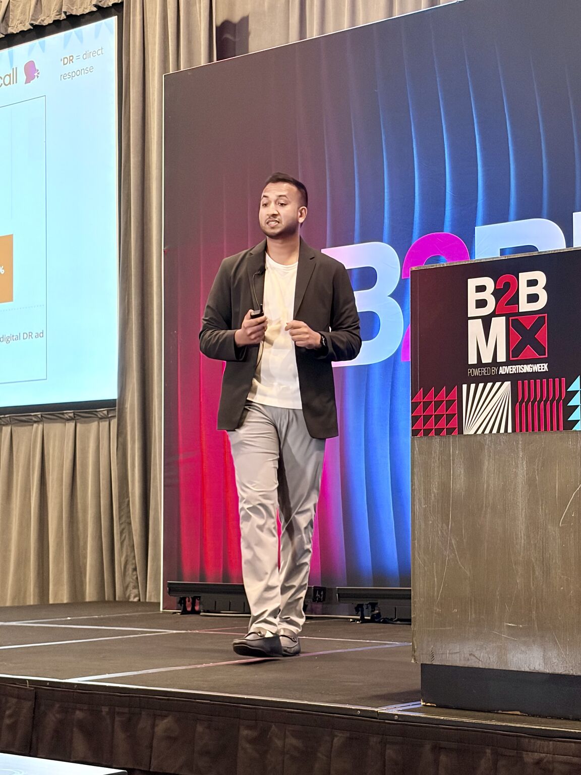 Kaushik Kumar speaking on stage at B2B MX, powered by Advertising Week